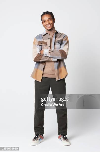 full length portrait of young man in studio - man full length stock pictures, royalty-free photos & images