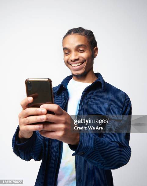 young man using smartphone - customer experience mobile stock pictures, royalty-free photos & images