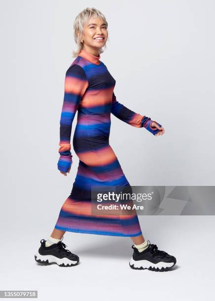 fashionable woman walking in studio - tie dye stock pictures, royalty-free photos & images
