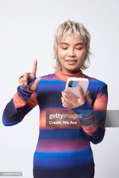 young woman using smartphone touch screen - smartphone woman photos et images de collection