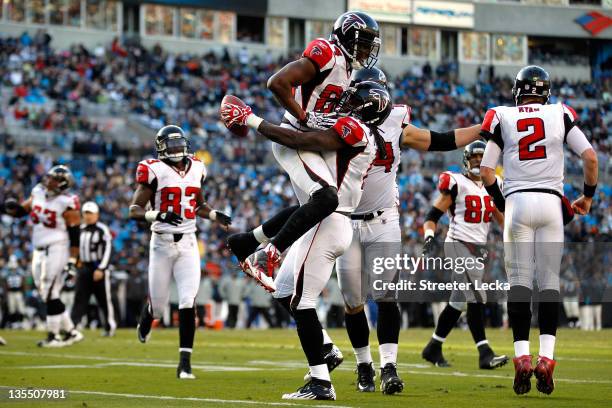 Julio Jones of the Atlanta Falcons celebrates after scoring a touchdown with teammate Roddy White during their game against the Carolina Panthers at...