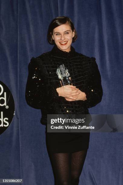 British singer and songwriter Lisa Stansfield, wearing a black jacket and black miniskirt, with her 'Best Newcomer' award in the press room of the...