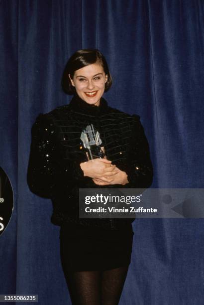 British singer and songwriter Lisa Stansfield, wearing a black jacket and black miniskirt, with her 'Best Newcomer' award in the press room of the...