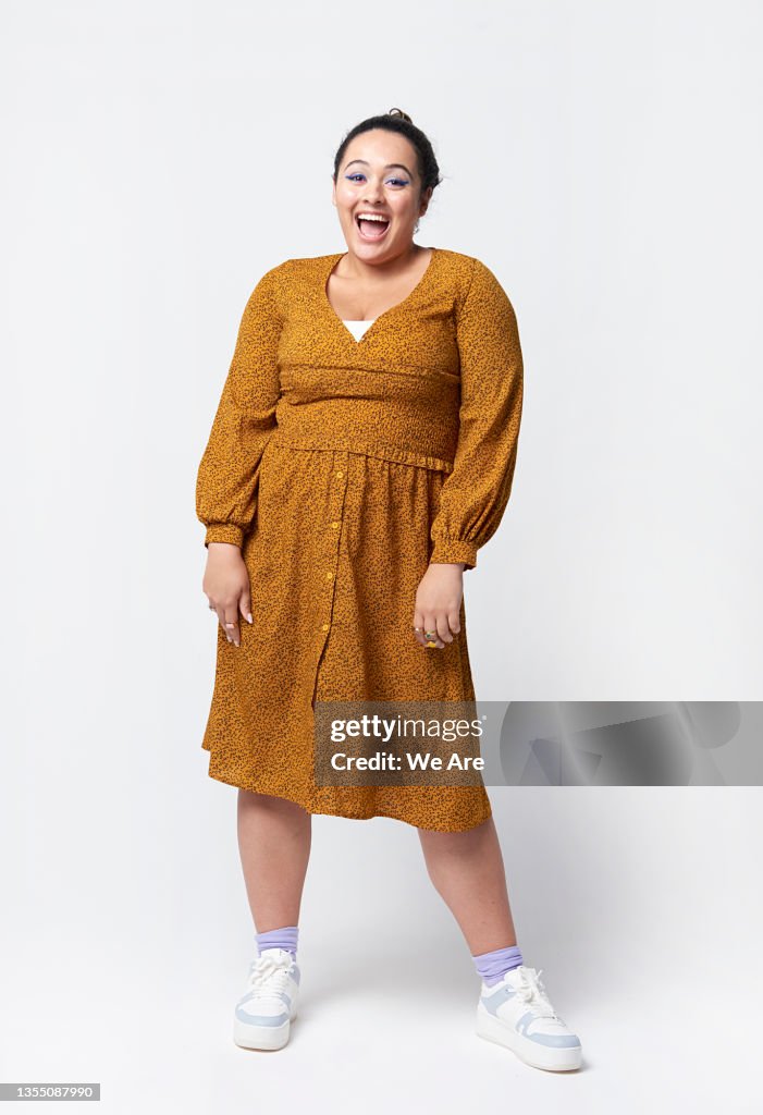 Full length portrait of confident young woman in studio