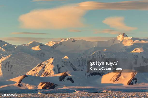 mountain landscape at sunset in east antarctica - antarctica sunset stock pictures, royalty-free photos & images