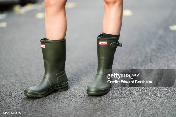 Emy Venturini wears khaki ankle rain boots from Hunter, during a street style fashion photo session, on November 18, 2021 in Paris, France.