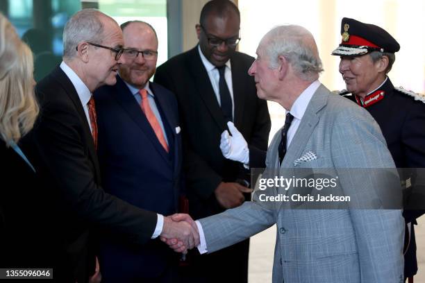 Prince Charles, Prince Of Wales is greeted by UK's Chief Scientific Advisor Patrick Vallance during a visit at the AstraZeneca global Research and...