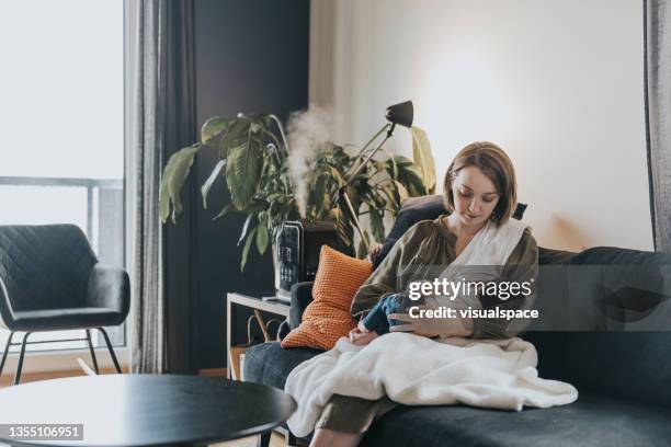 mother breastfeeding her newborn baby - humidifier stock pictures, royalty-free photos & images