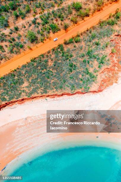 broome coastline, car on red unpaved road. western australia. aerial drone view - western australia road stock pictures, royalty-free photos & images