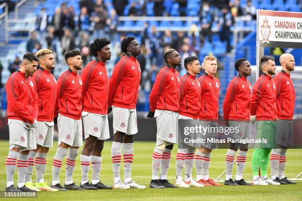 Members of Toronto FC stand during the anthem prior to the game against CF Montréal during the 2021 Canadian Championship Final at Stade Saputo on...