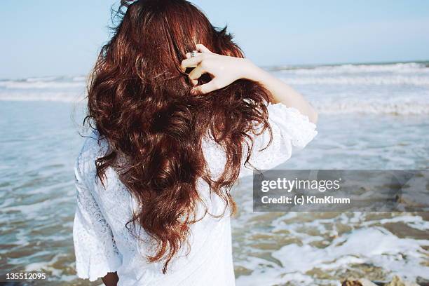 girl looking at beach - dyed red hair stock-fotos und bilder