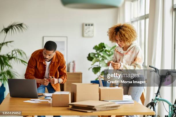 male and female colleagues working at home office - doing a favor stock pictures, royalty-free photos & images
