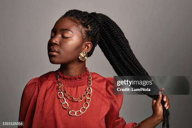 shot of a beautiful young woman posing against a grey background - plait stock pictures, royalty-free photos & images