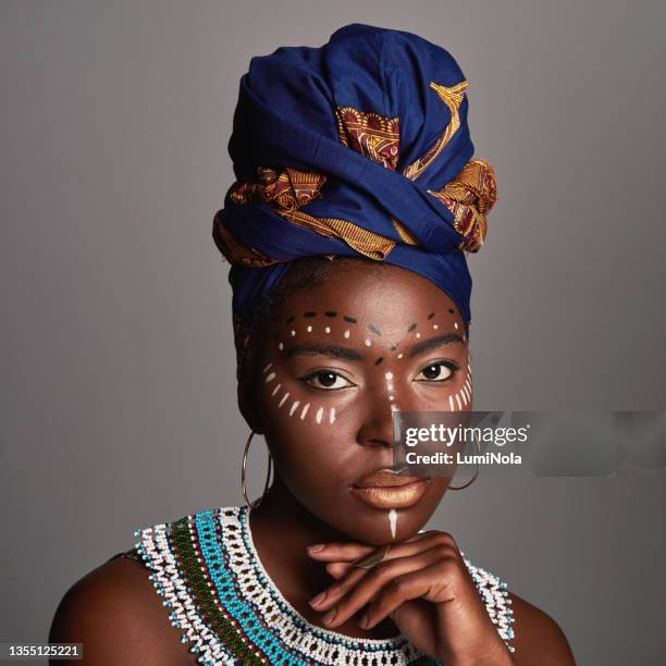 studio shot of a beautiful young woman wearing traditional african attire - africa pattern stock pictures, royalty-free photos & images