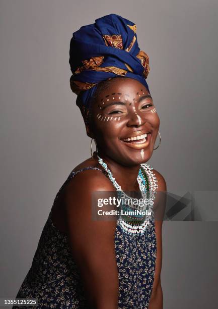 studio shot of a beautiful young woman wearing traditional african attire - african tradition stock pictures, royalty-free photos & images