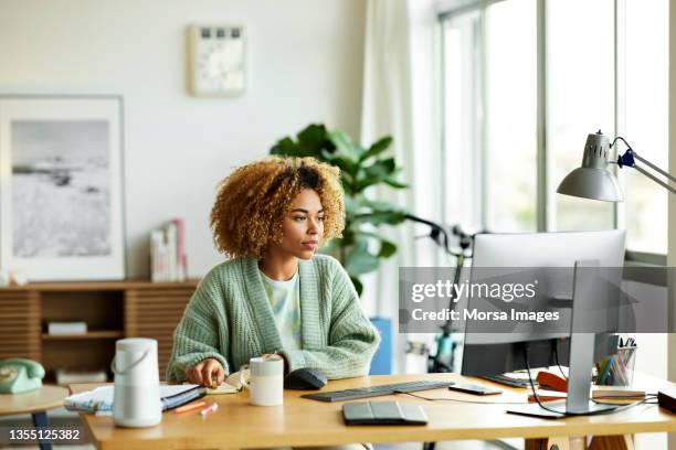 businesswoman using computer at home office - computer front view stock pictures, royalty-free photos & images