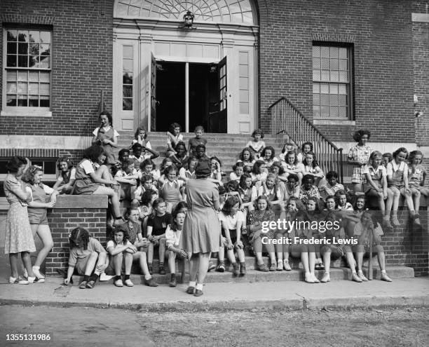 Teacher talks to a group of teenage girls at Benjamin Franklin Junior High School, Ridgewood, New Jersey, US, circa 1960.