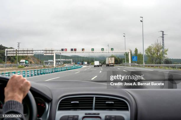 car point of view, luminous signs on a highway to regulate traffic in a tunnel area. - car point of view stock pictures, royalty-free photos & images