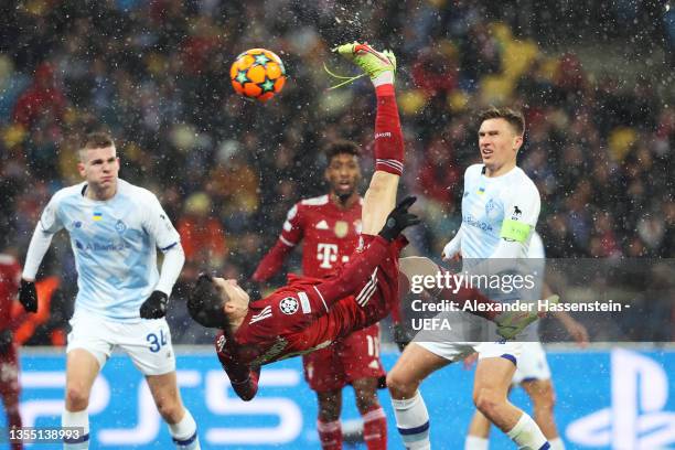 Robert Lewandowski of FC Bayern Muenchen scores their side's first goal with an overhead kick during the UEFA Champions League group E match between...