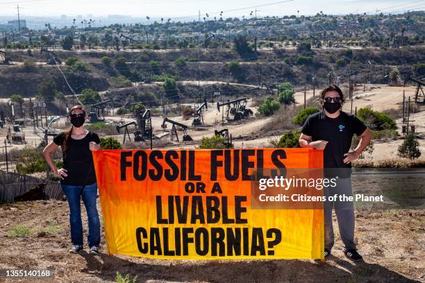 Activists gather near Inglewood Oil Field in Los Angeles, one of the largest contiguous urban oil fields in the country, to urge the Governor of...