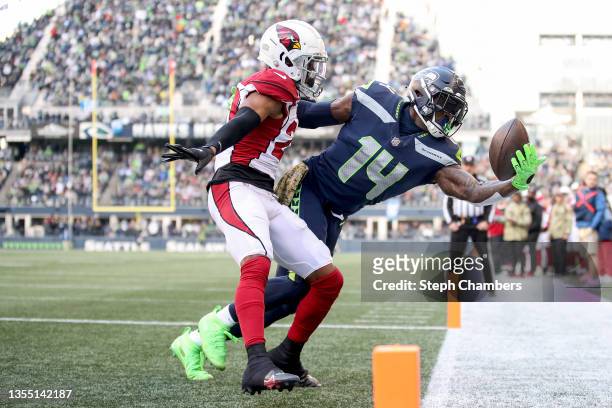 Metcalf of the Seattle Seahawks attempts to make a catch in front of Marco Wilson of the Arizona Cardinals in the endzone but is unable to get both...