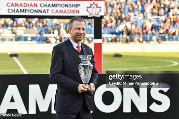 Canada Soccer President Nick Bontis, holds up the George Gross Memorial Trophy given to the MVP of the competition between CF Montréal and the...