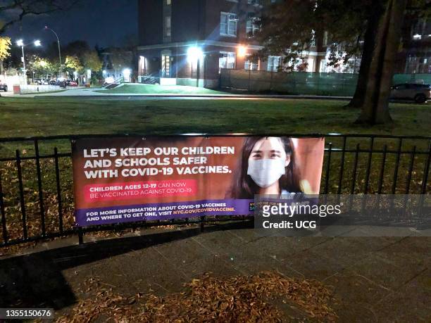 Keep Children and schools safer with Covid 19 vaccines banner outside Forest Hills High school, Queens, New York.