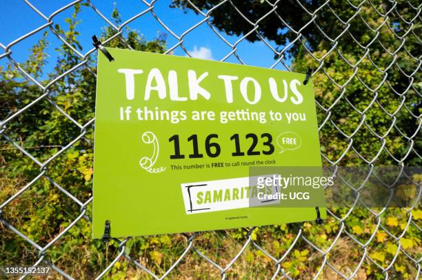 Samaritans sign with telephone helpline number.