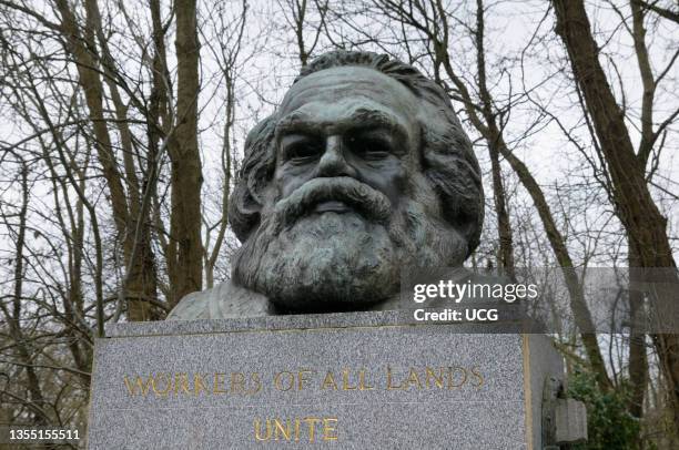 Bronze bust above the tomb and grave of famous 19th century philosopher and revolutionary Karl Marx in Highgate Cemetery in north London.