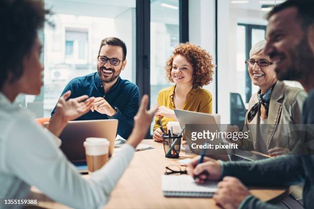business people sitting around the table and talking - brainstorming stock pictures, royalty-free photos & images
