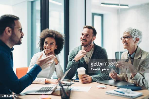 businessman speaking during a meeting - business meeting stock pictures, royalty-free photos & images
