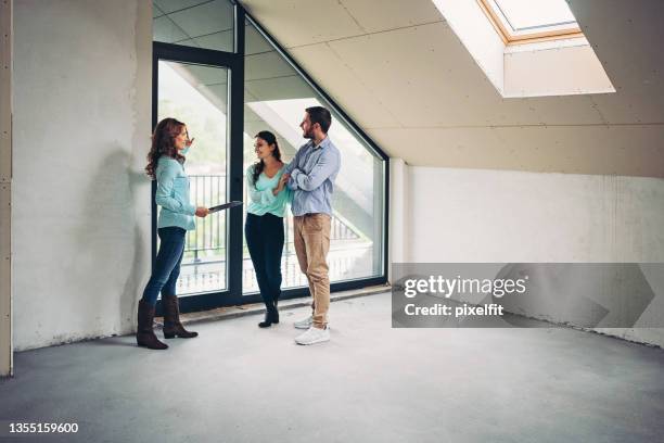 property agent showing apartment for sale - property developer stock pictures, royalty-free photos & images