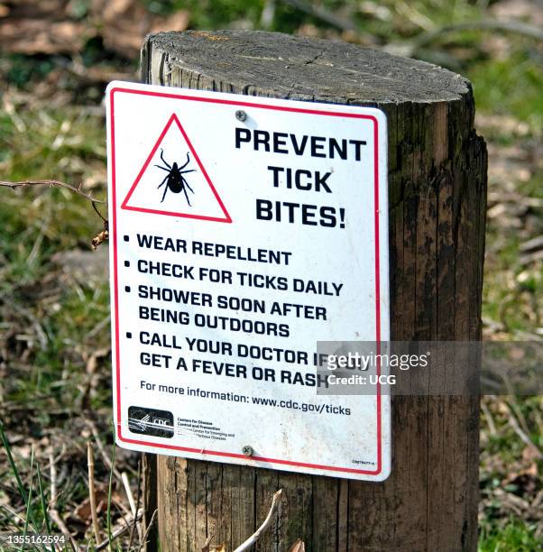 Prevent Tick Bites Sign posted on hiking trail.