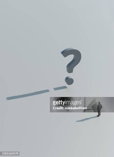 entrepreneur stands before a gigat question mark - problem solution stock pictures, royalty-free photos & images