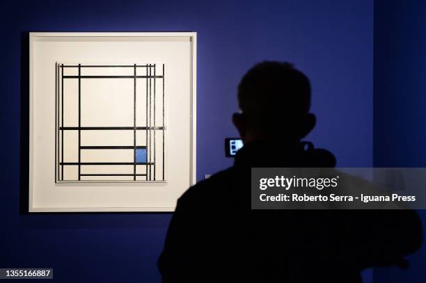 Visitors admires the dutch artist Piet Mondrian's masterpieces of the "Piet Mondrian From Figuration To Abstraction" exhibition at MUDEC on November...