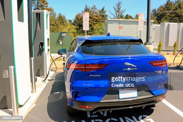 Jaguar I-Pace plug-in EV electric car plugged in at charging station, This car was charging at a retail charging station in Lincoln City Oregon.
