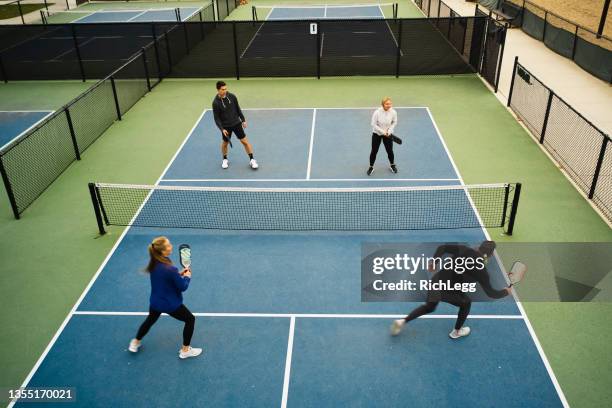 young adults playing pickleball - doubles sports stock pictures, royalty-free photos & images