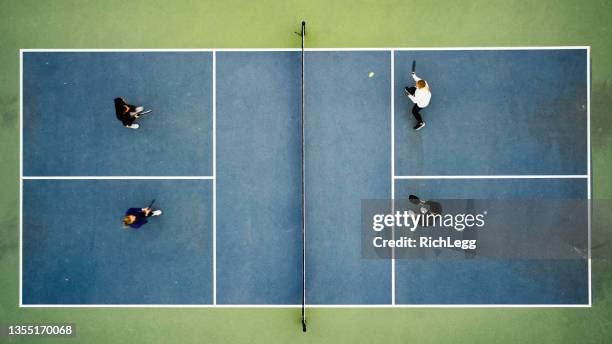 young adults playing pickleball - double stockfoto's en -beelden