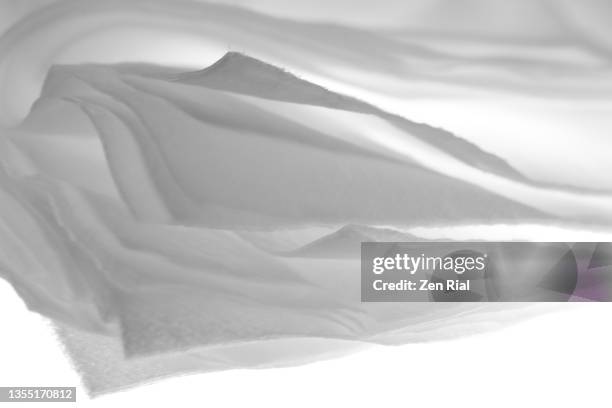white facial tissue paper focused on edges against white background - papiertaschentuch stock-fotos und bilder