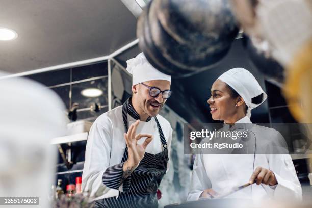 happy cook learning to cook from the chef - happy cooks stock pictures, royalty-free photos & images