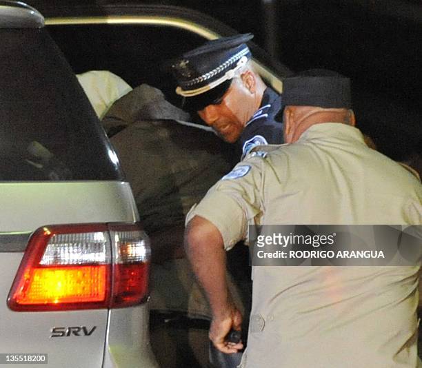 Panama's former dictator Manuel Noriega is helped tio sit on a wheelchair upon arrival at Renacer prison, 25 km south east of Panama City, on...