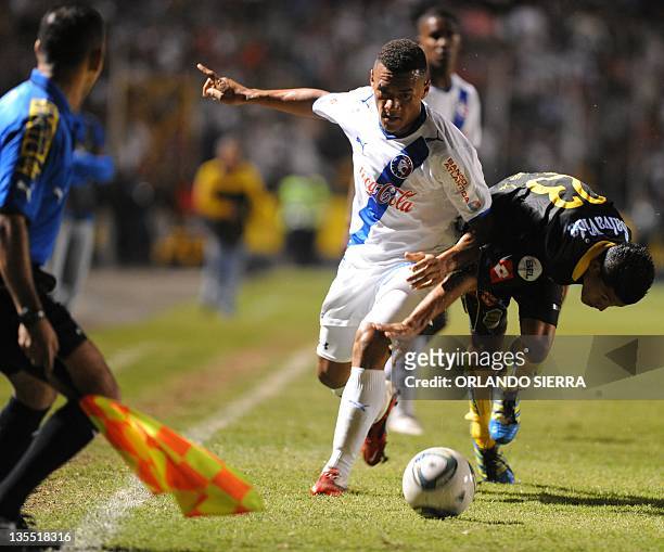 Olimpia's Carlos Will Mejia vies for the ball with Real Espana's Eder Delgado, during their Honduran Apertura Tournament second leg final match, in...