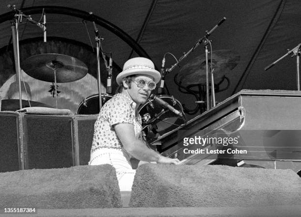 English singer, pianist and composer Elton John performs on stage during the West of the Rockies tour on October 25, 1975 at Dodger Stadium in Los...