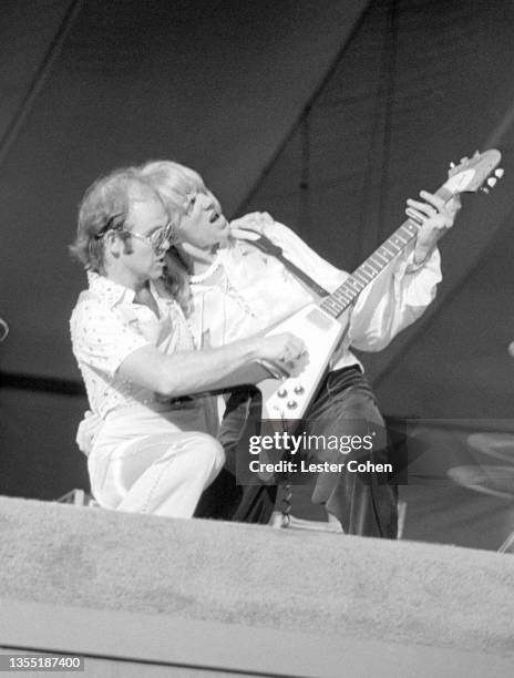English singer, pianist and composer Elton John and Scottish rock guitarist and vocalist Davey Johnstone play the guitar during the West of the...