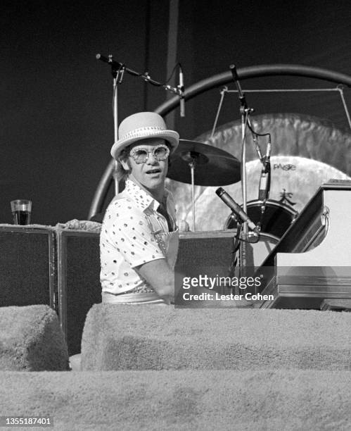 English singer, pianist and composer Elton John performs on stage during the West of the Rockies tour on October 25, 1975 at Dodger Stadium in Los...