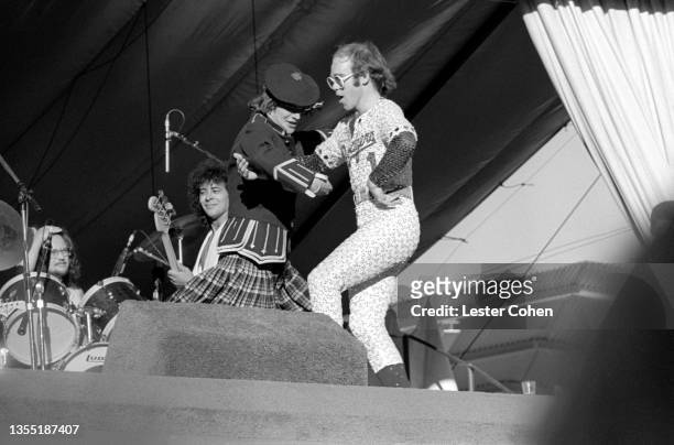 English singer, pianist and composer Elton John dances on stage during the West of the Rockies tour on October 25, 1975 at Dodger Stadium in Los...