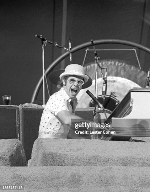 English singer, pianist and composer Elton John performs on stage during the West of the Rockies tour on October 25, 1975 at Dodger Stadium in Los...