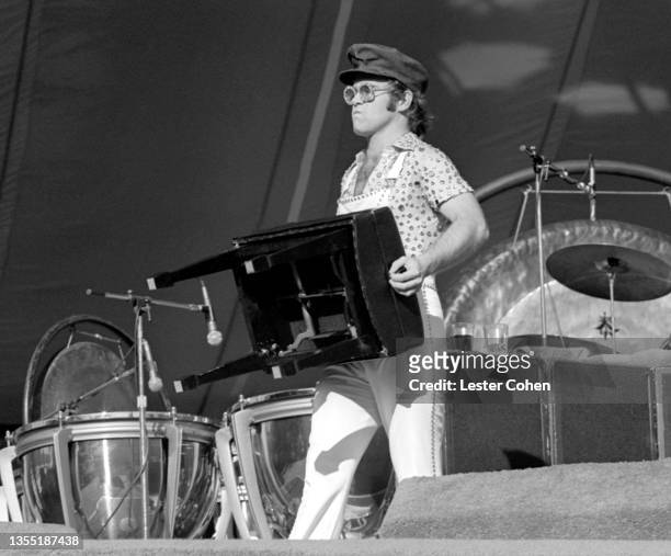 English singer, pianist and composer Elton John moves his piano chair on stage during the West of the Rockies tour on October 25, 1975 at Dodger...