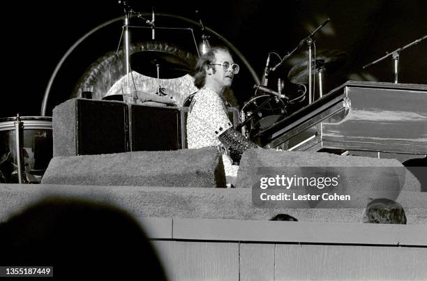 English singer, pianist and composer Elton John performs on stage during the West of the Rockies tour on October 25, 1975 at Dodger Stadium in Los...