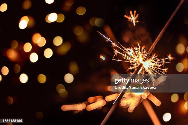 festive burning sparkles at new year celebration party - nieuwjaar stockfoto's en -beelden
